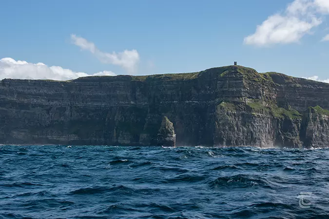 Looking up at the Cliffs of Moher from water