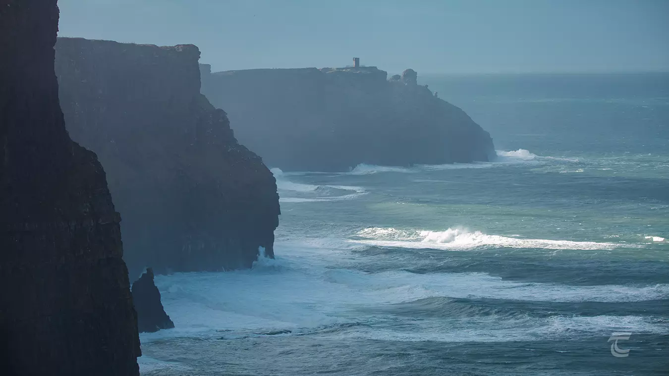 the staggered Cliffs of Moher being battered by the wild atlantic ocean