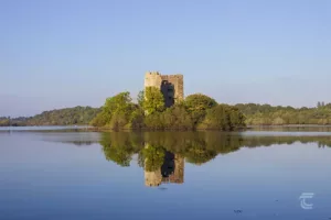 Clough Oughter Castle reflected in the water of Lough Oughter in Cavan Ireland's Ancient East
