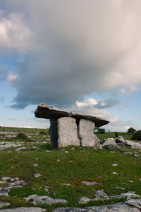 Portal tomb against a grey sky