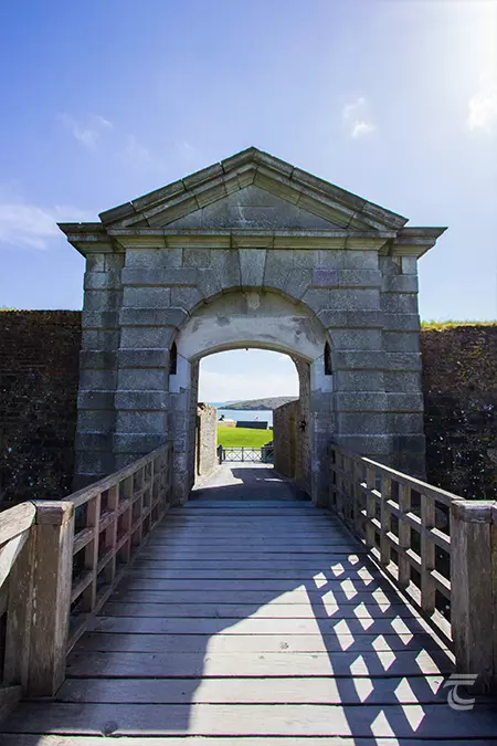 A wooden walkway leads to the entrance to Charles Fort