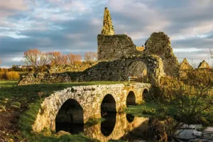 A medieval bridge and ruined gatehouse at Athassel Priory, Tipperary