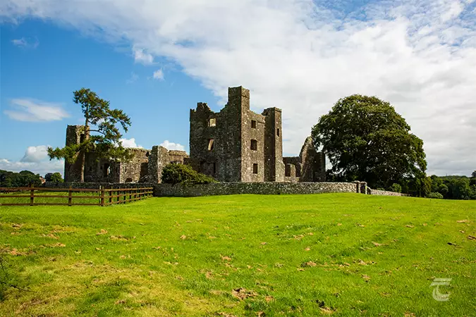 Bective Abbey, Meath. The abbey is enclosed by a stone wall and is situated in green pasture.