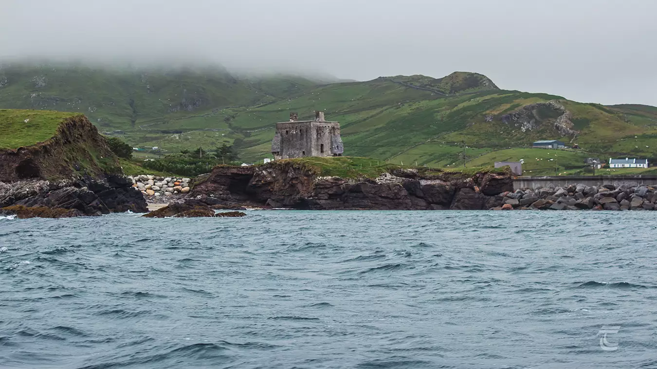 Approaching Clare Island, Mayo, with the medieval towerhouse, Granuaile's Castle visible on the coastline. 