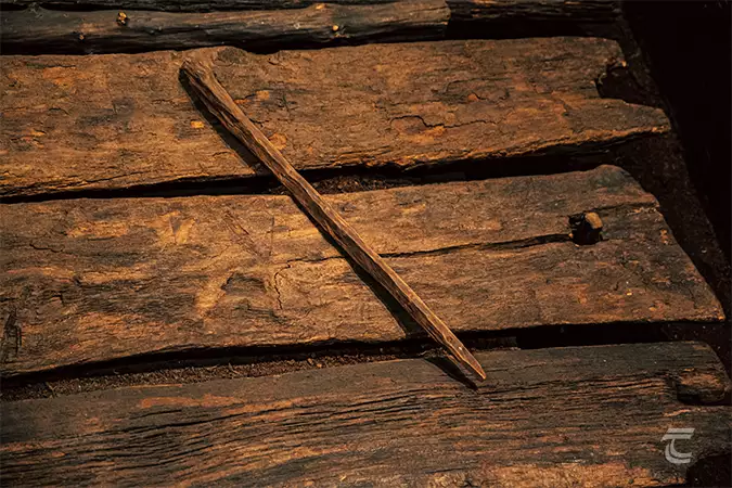 A wooden stake lying on the oak planks of the Corlea Trackway