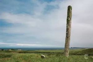 Doonfeeny Standing Stone, Mayo, with the Atlantic Ocean on the horizon. Also visible in the background is Downpatrick Head.
