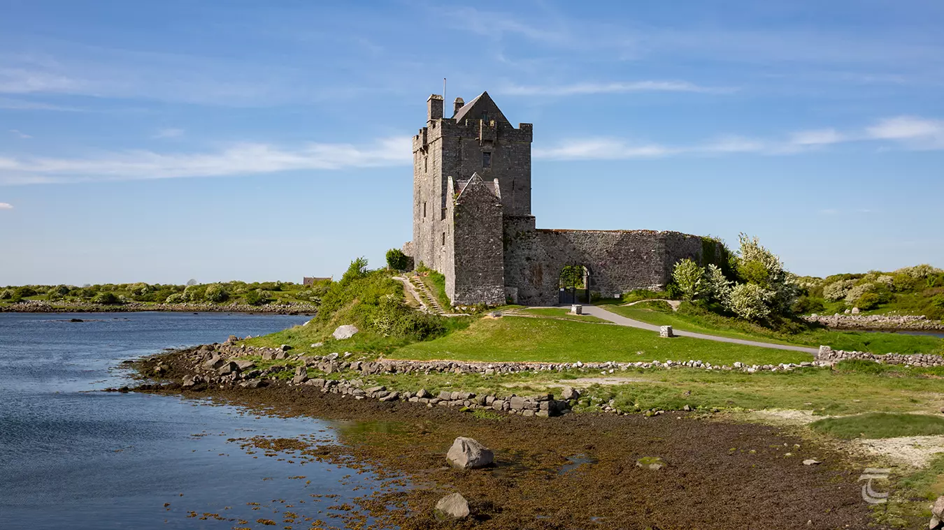 Dunguaire Castle stands above Galway Bay in the sunshine 