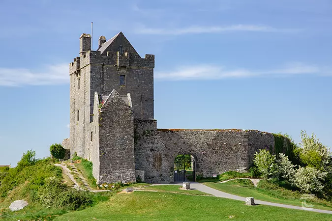 Dunguaire Castle from the south standing atop a grassy hill