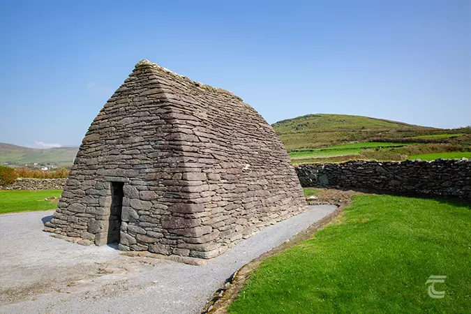 The Oratory surrounded by green fields on a bright day