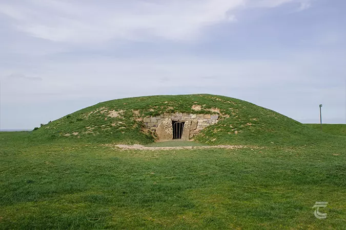 The monument known as the Mound of the Hostages on the Hill of Tara. A low earthen mound with a stone framed entrance