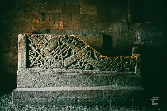 An ornate stone sarcophagus with interlaced beasts inside Cormacs Chapel on the Rock of Cashel