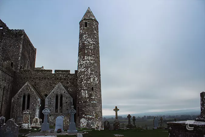 The Round Tower on the Rock of Cashel a tall tapering tower with a conical cap