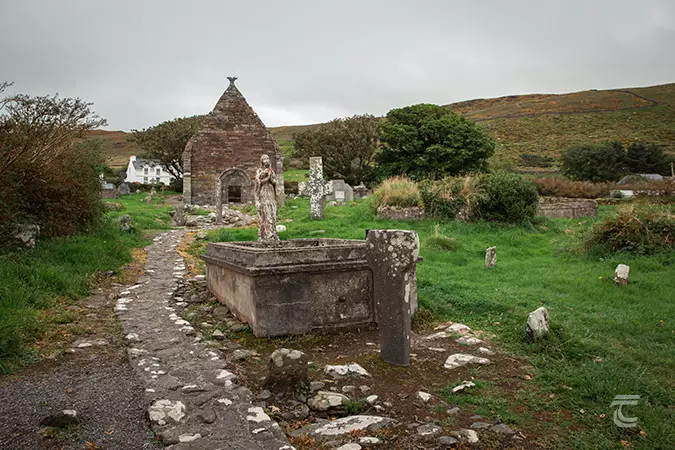 Ogham stone and stone cross in the graveyard of Kilmalkedar Church, Kerry.