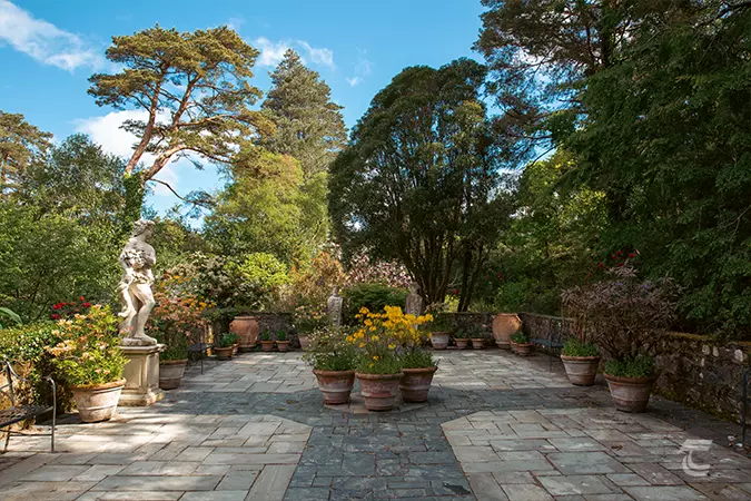 Paved area with shrubs and ornamental flowers in the italianate style