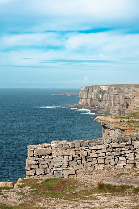 The cliffs at Dún Aonghasa (Dún Aengus Cliffs) sheer limestone rock soaring from the deep blue Atlantic Ocean