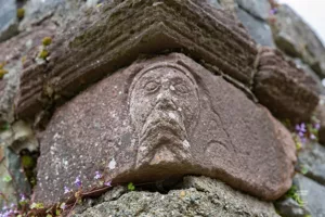 A romanesque face in the church of Innisfallen Abbey on Innisfallen Island Kerry. It may represent St Finian
